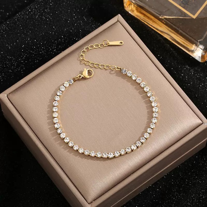 Eon 18K gold plated stainless steel tennis bracelet featuring brilliant round-cut 5A cubic zirconia crystals with an adjustable lobster clasp.