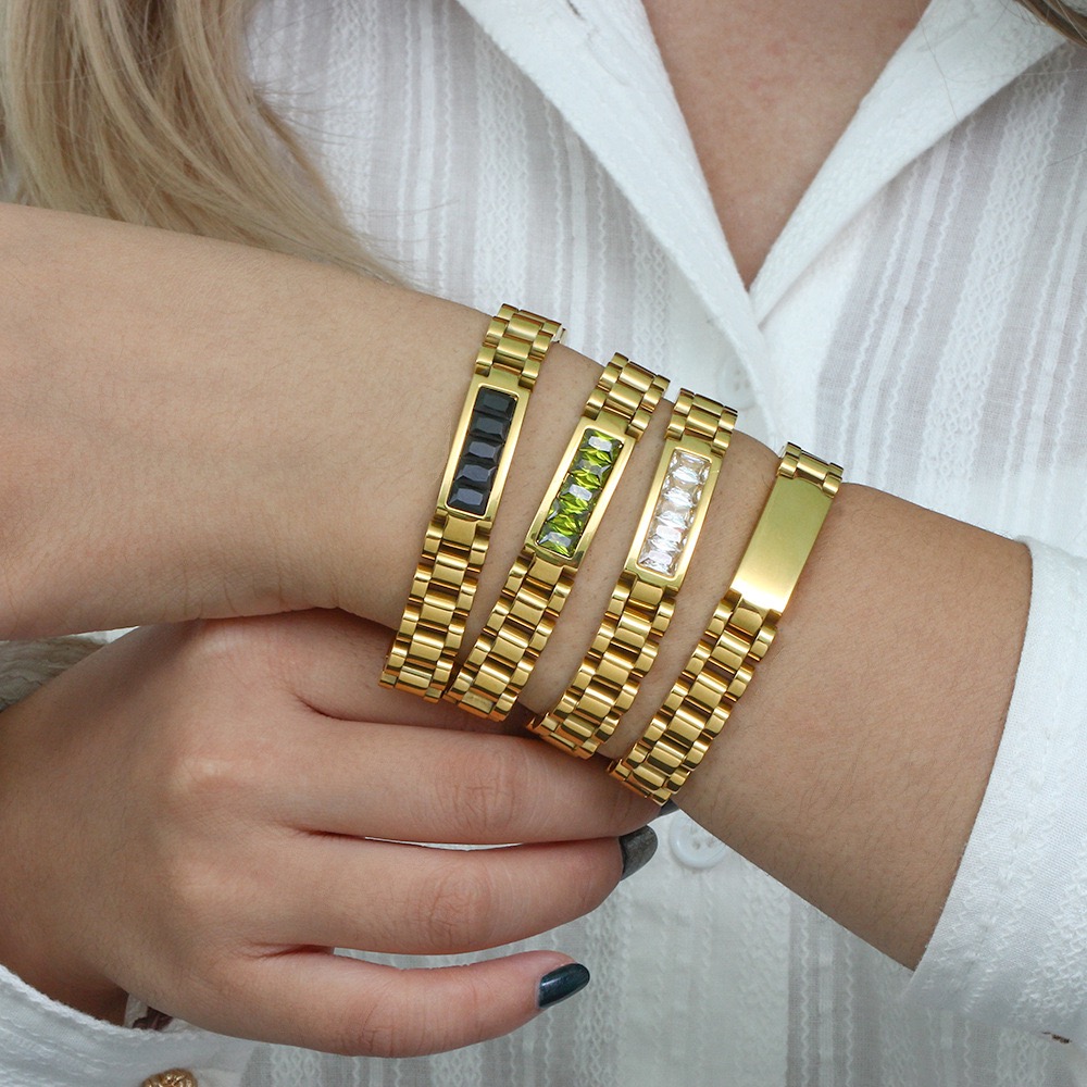 Luxury gold plated stainless steel crystal link bracelet by KemisJewel. Watch-inspired gold bracelet with emerald green crystal centre. Elegant gold bracelet featuring black crystal detailing. Minimal